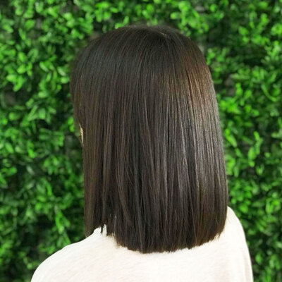 shows the back of a woman's head with long straight hair